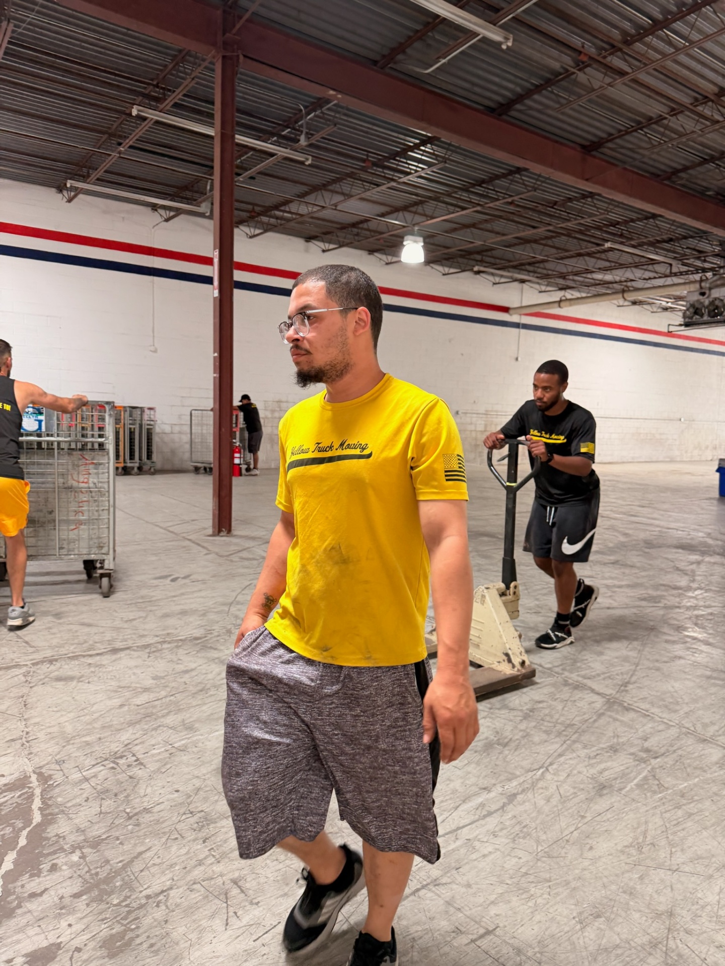 Yellow Truck Moving team member in branded yellow shirt at a job site