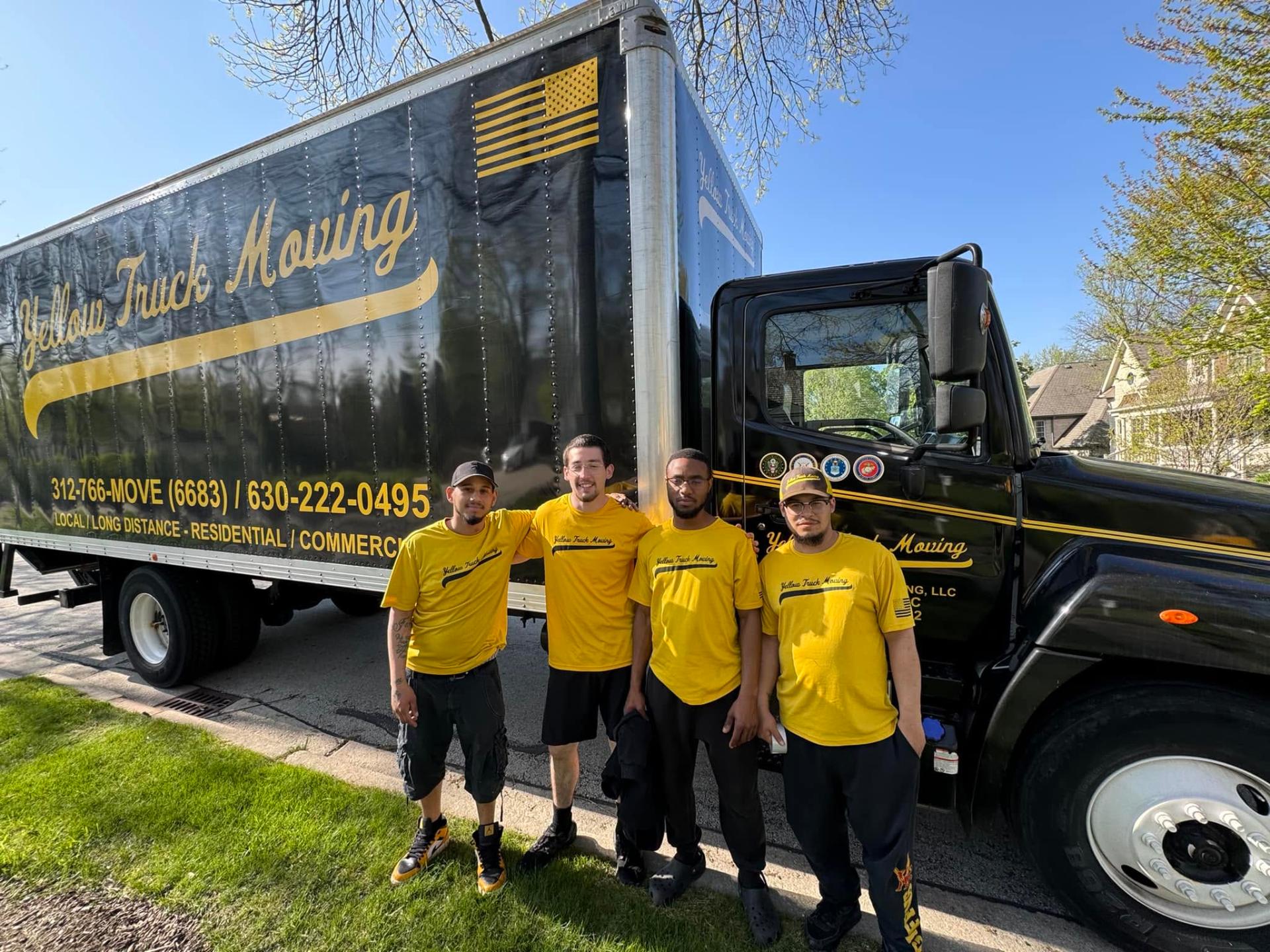 Yellow Truck Moving crew in yellow shirts in front of the black-and-gold branded truck