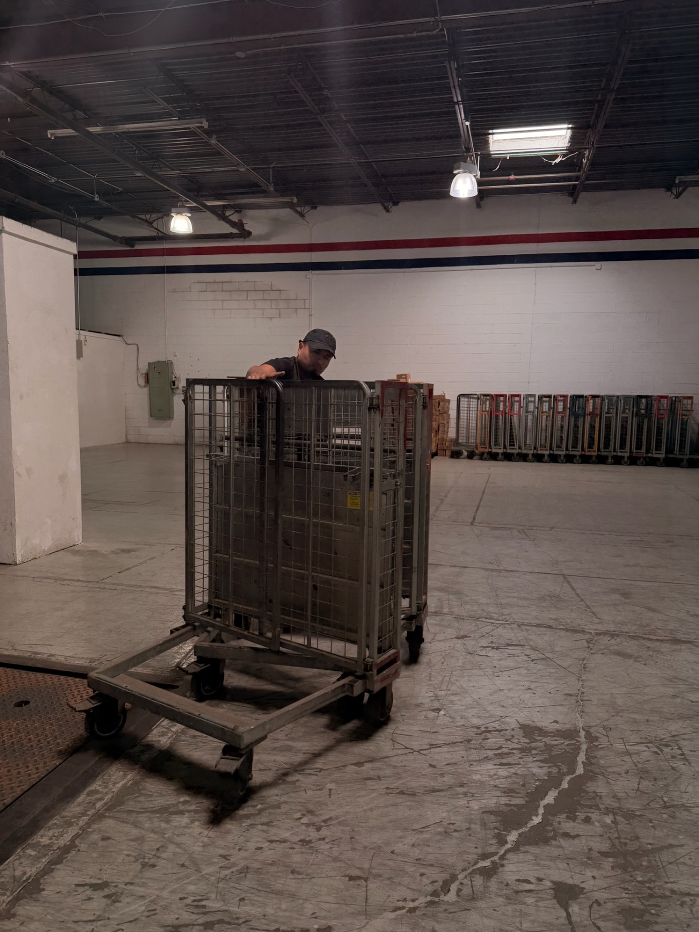 Yellow Truck Moving crew member maneuvering moving carts in a facility